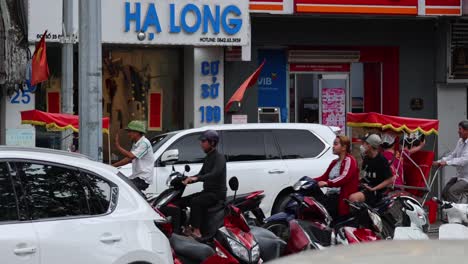 motorbikes and cars navigating a crowded street