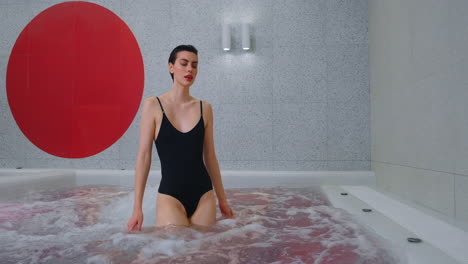 woman relaxing in a modern indoor hot tub