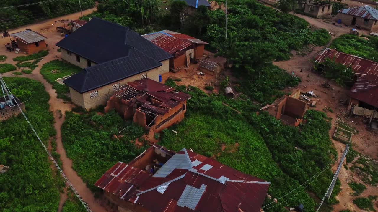 Aerial of a large old mud house with a collapsed shed in a small, rural village in Ibadan, Oyo, Nigeria, Africa