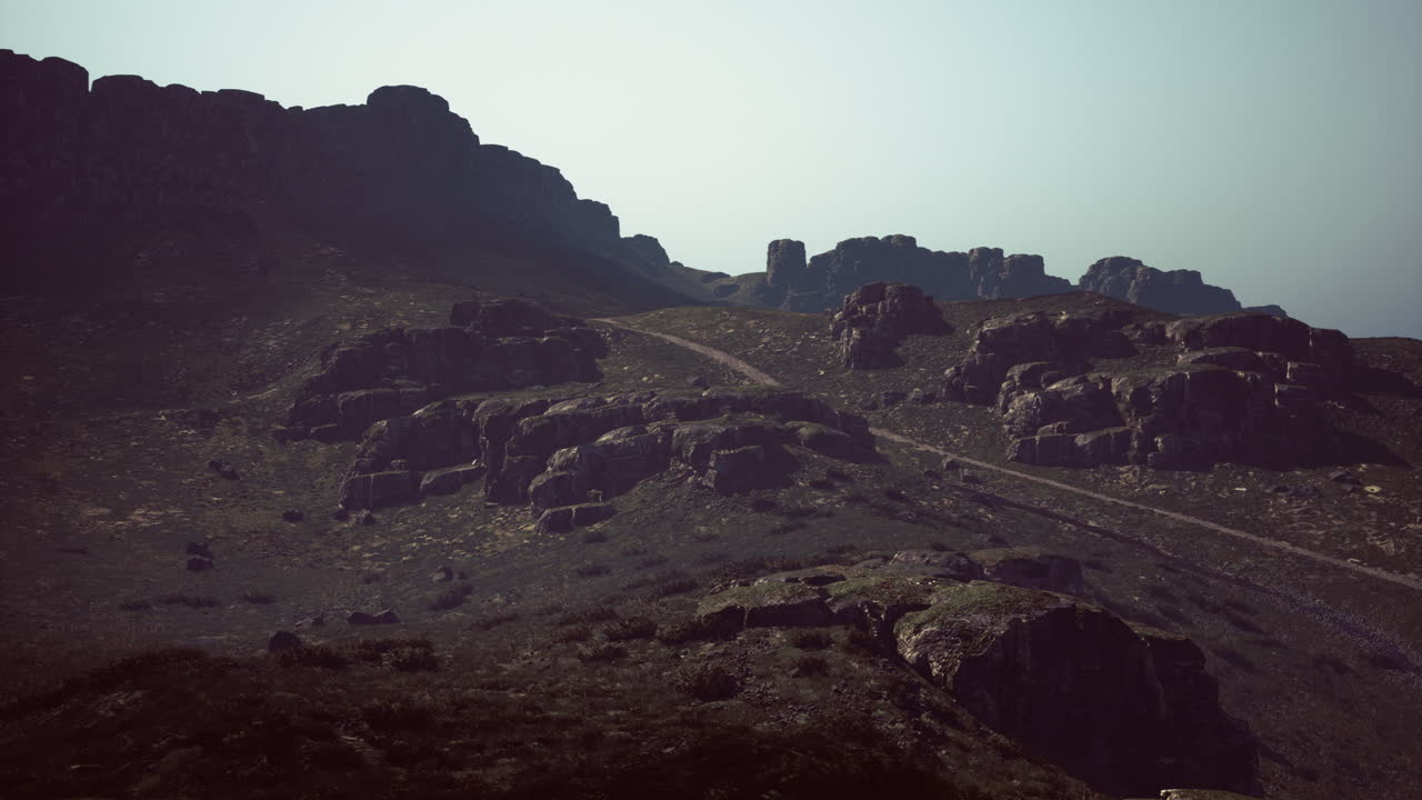 Exploring rugged mountain terrain at dusk with rocky formations in view