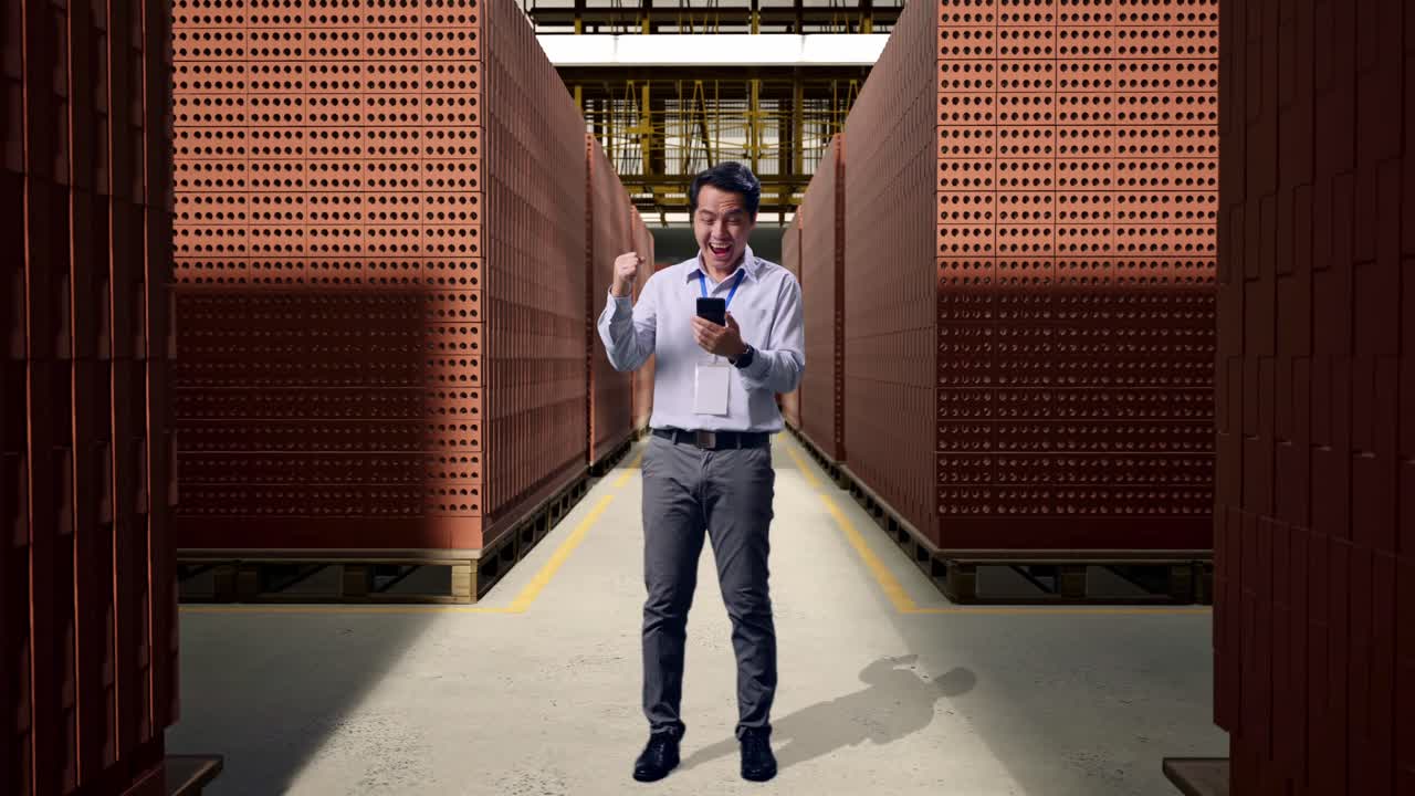 Happy Worker Celebrating Success in a Brick Warehouse