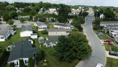 aerial of single story trailer home mobile park homes in united states, village community neighborhood on quiet summer afternoon day