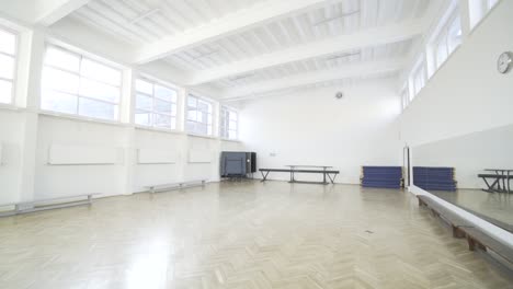 a small sports hall in public high school with big mirrors on the wall