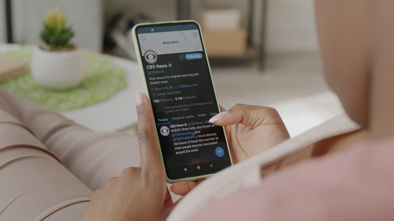 Person using a smartphone to read news