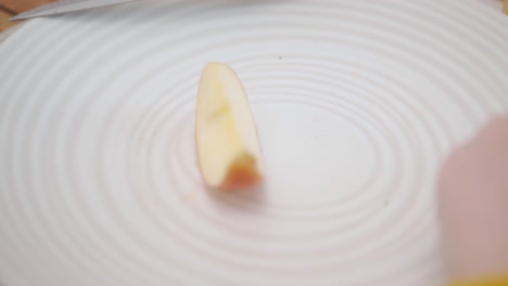 Mano-De-Mujer-Tomó-Manzana-En-Rodajas-En-El-Plato---Cerrar