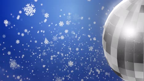 Animation-of-snowflakes-and-disco-ball-on-blue-background