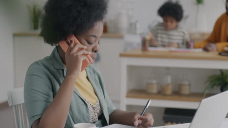 woman working from home while children are present