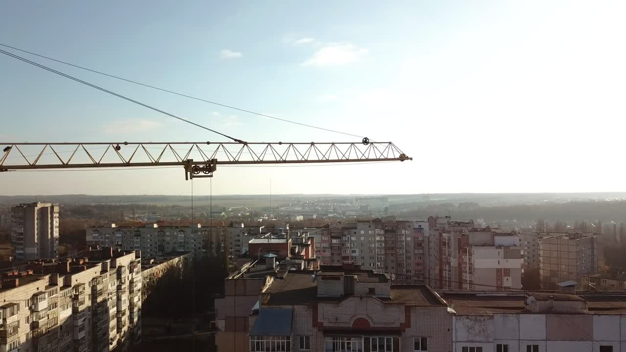 Yellow crane under construction. Construction site with yellow crane and building on background of sky
