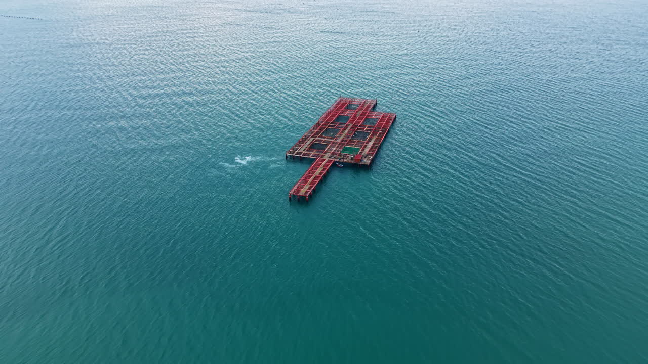 Mussel farm located in the sea with floating structures and calm water under clear sky