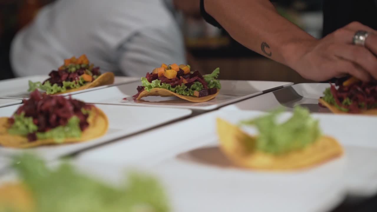 Chef prepared many white plates of Guatemala food to serve, close up handheld view