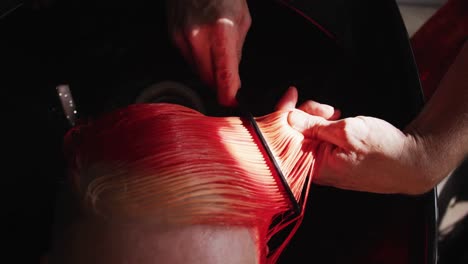 close up view hairdresser brushing woman hair