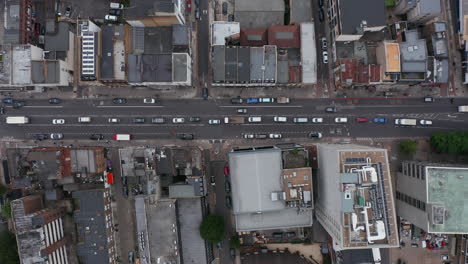 Aerial-birds-eye-overhead-top-down-panning-view-cars-slowly-and-intermittently-moving-through-street.-London,-UK