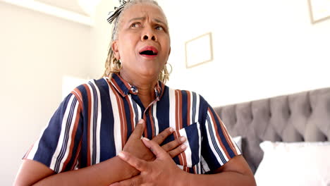 a senior african american woman with short gray hair is looking surprised