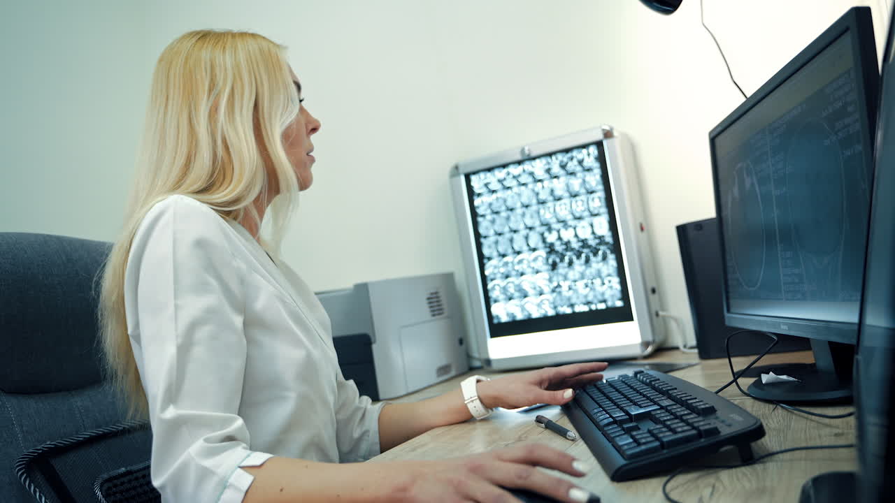 Female radiologist reviewing medical scans