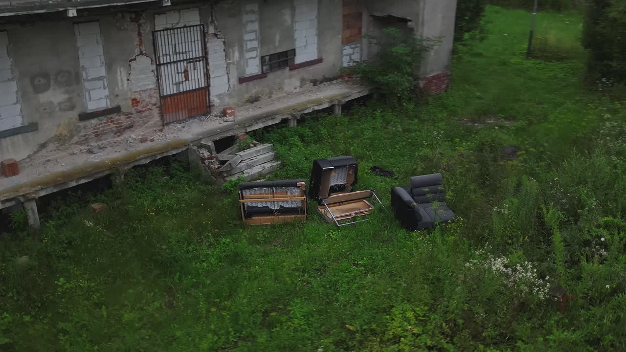Discarded furniture outside derelict post-industrial workers apartments
