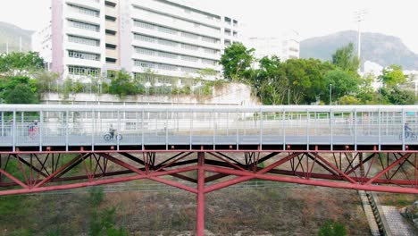 cyclists at po kong village road park elevated cycling track, downtown hong kong, high altitude aerial footage