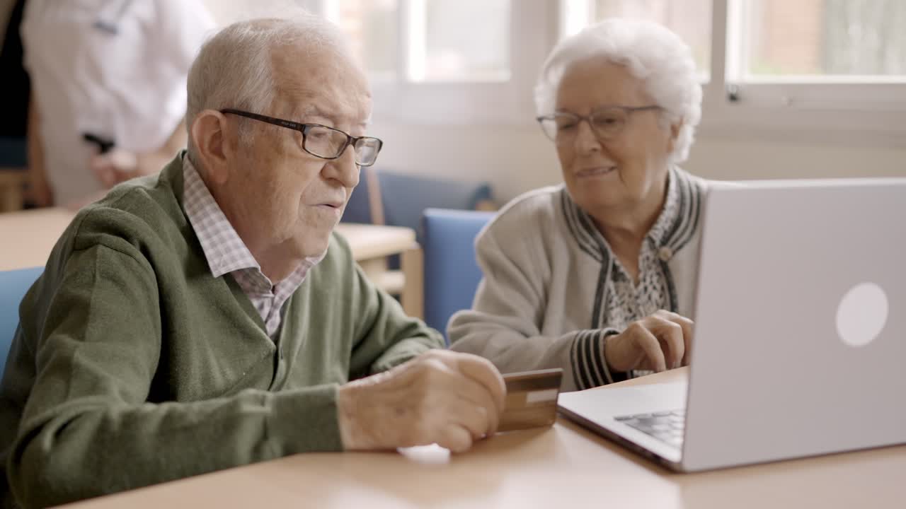 Senior people trying to shop online with laptop in geriatric