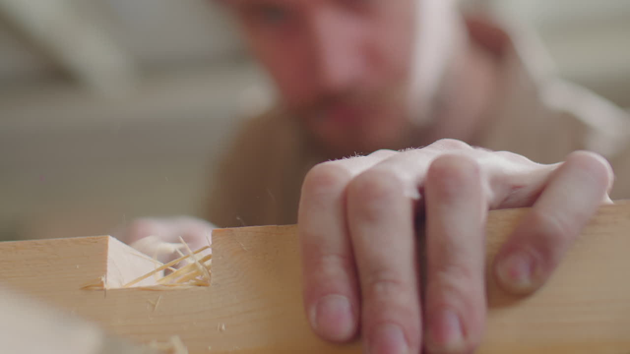 Man Chiseling Mortise in Wood