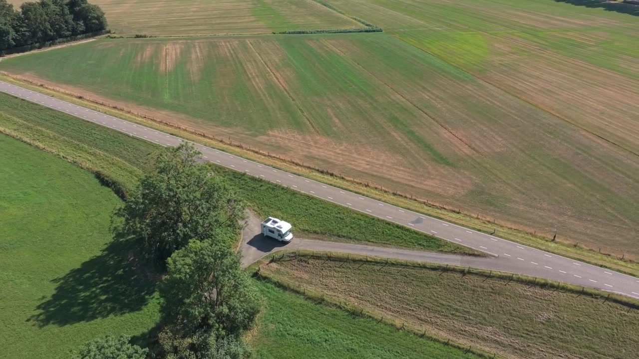 Aerial View of a Camper Van Parked Near a Rural Road