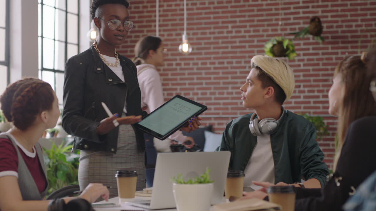 creative group of business students meeting african american team leader woman using digital tablet computer sharing ideas discussing project in diverse trendy office