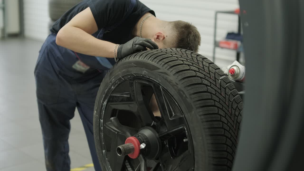 Mechanic working on a car tire
