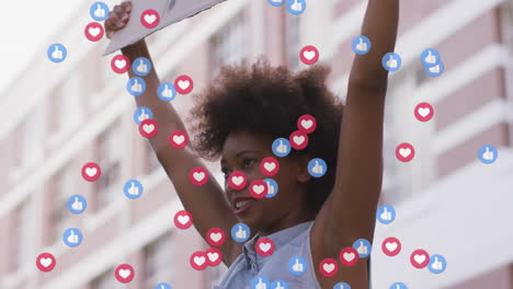 animation of social media icons over african american holding a placard during a protest