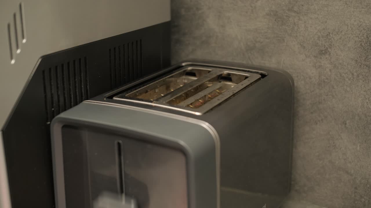 Bread Slices Popping Up from a Modern Toaster