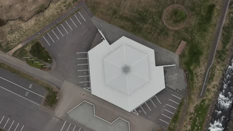 Top-down-aerial-of-Eskifjordur-Church-in-Iceland,-house-of-prayer