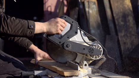 man saws boards with a circular saw