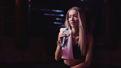 Slow-Motion-Of-Young-Athletic-Woman-Drinking-Water-From-Bottle-In-Gym