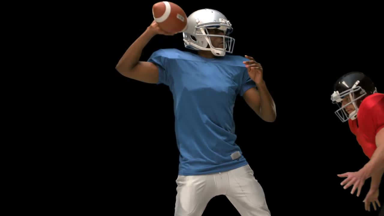 Giocatore di football americano serio che placa per il pallone