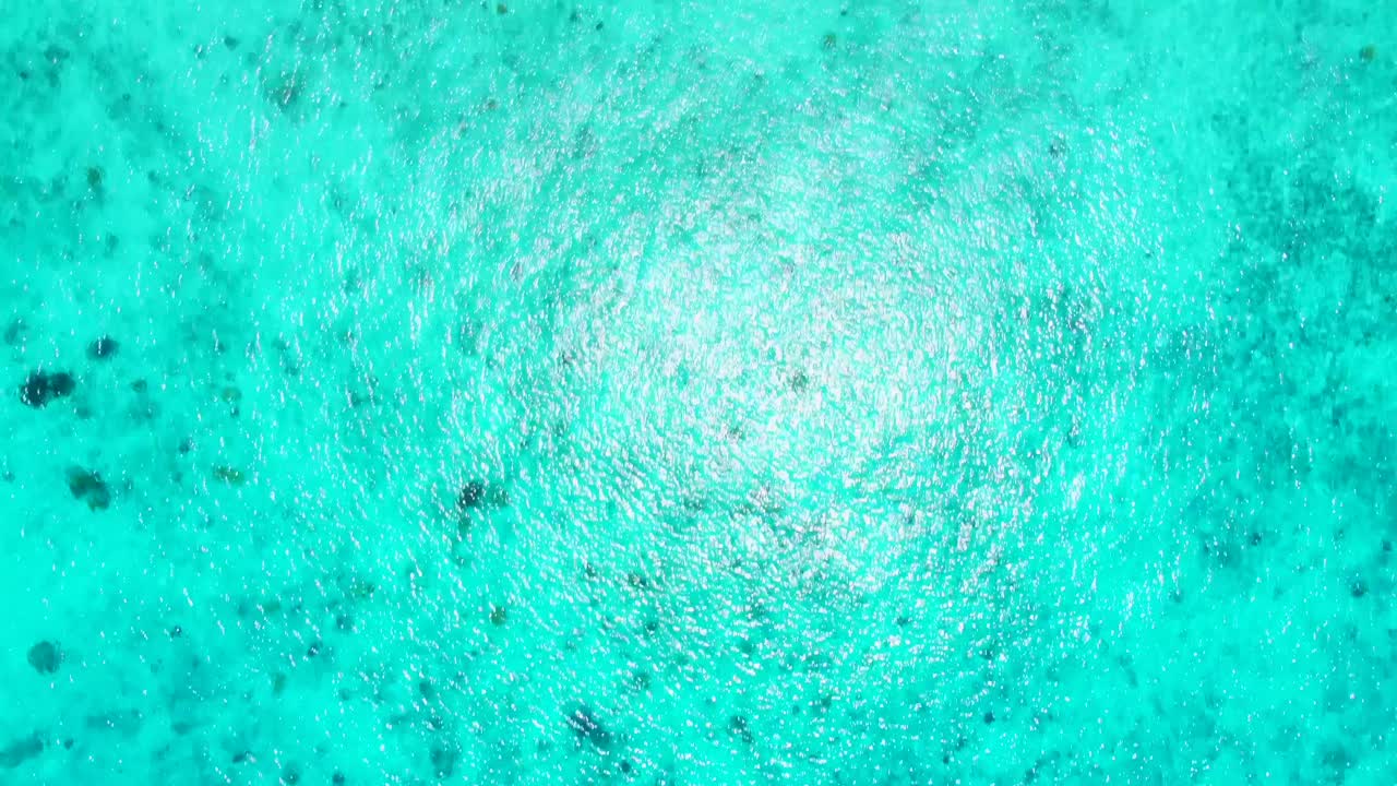 Birdseye Aerial Over Turquoise Water with Swimmers next to beautiful beach with palapas