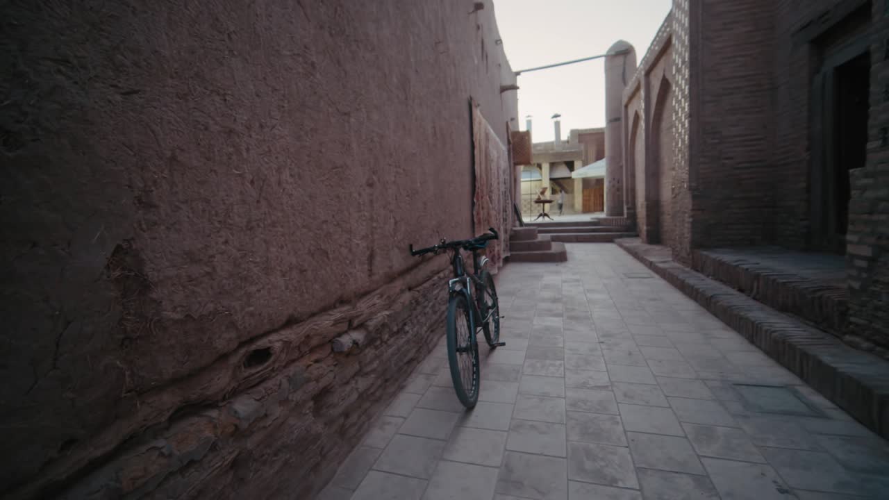 Khiva Ichan Kala Fortress old streets near Mausoleum bicycle evening, Uzbekistan
