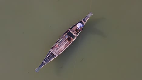 majestic overhead view of lonely fisherman on board of typical asian boat