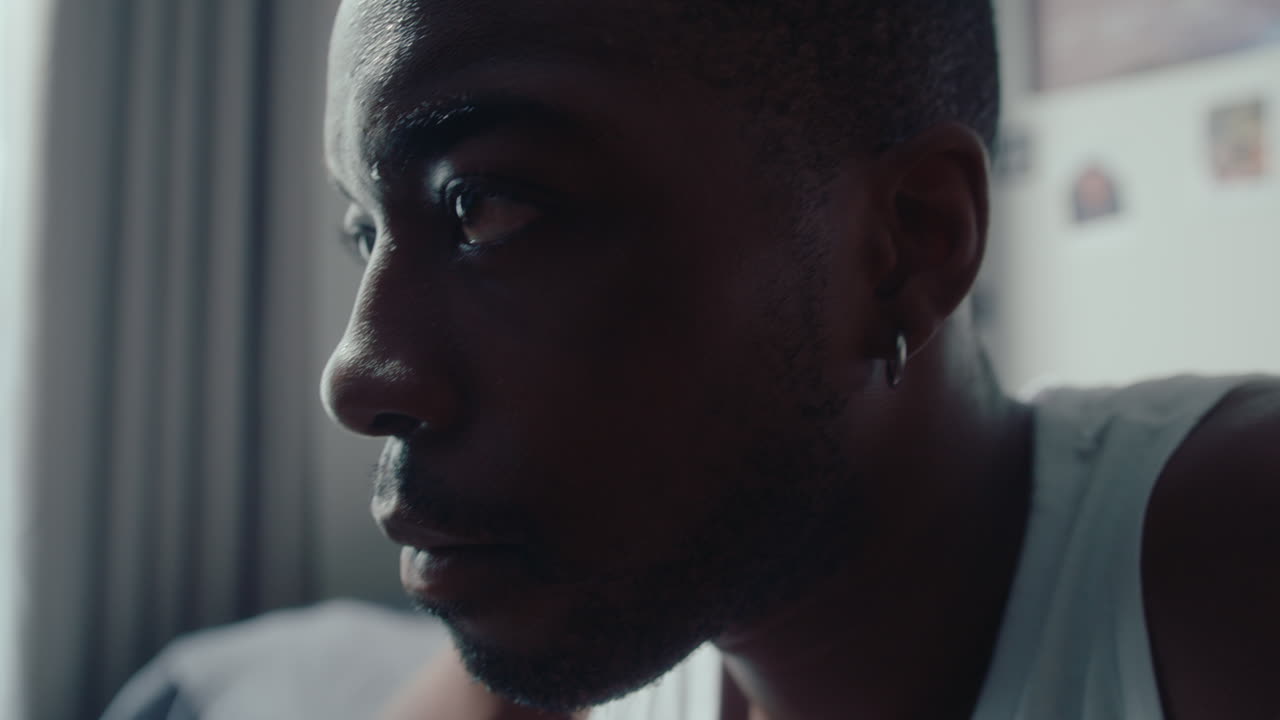 Young Pensive Black Man Sitting in the Bedroom