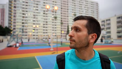 tourist man looking around choi hung estate basketball court, hong kong