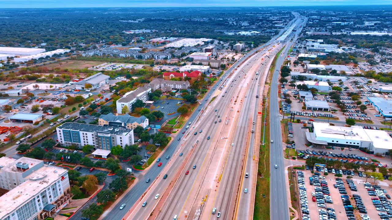 Austin, USA, 24 November 2025: Wide multi-lane highway with the numerous cars. Hectic traffic in the metropolis at daytime. Aerial view