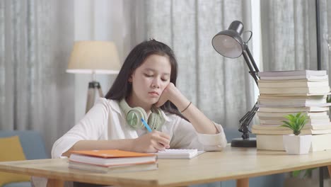 teenage girl studying at home