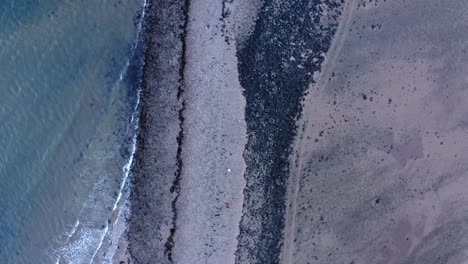 AERIAL---Top-down-view-of-coastline-of-Island-Davaar,-Kintyre,-Scotland,-forward