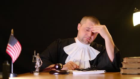 an experienced judge reflects on complex legal matters at a desk with books and a gavel for authority