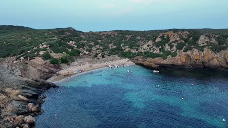 drone flying forward over the amazing little island beaches on menorca.