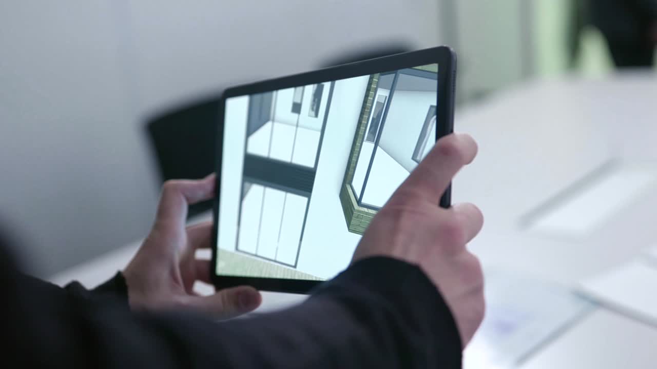 persona que utiliza una tableta para el diseño de una casa virtual