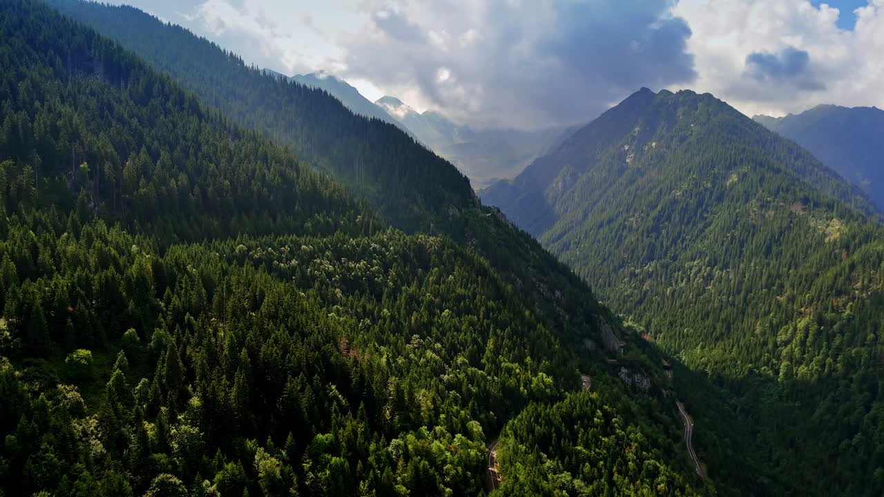 Mountain forest views. Lush green mountains stretch across the landscape under a cloudy sky, showcasing the beauty of nature in the region