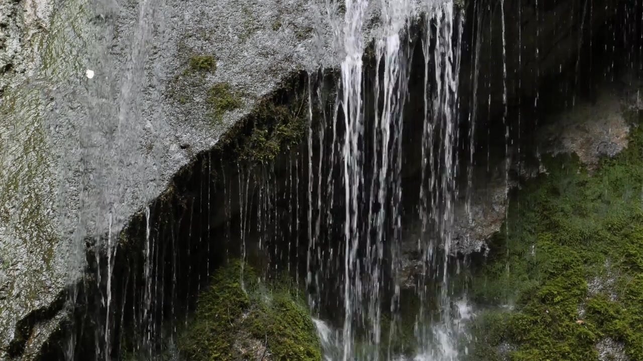 Cascading water flowing over moss-covered rocks in Wimbachklamm gorge, Bavaria, Germany