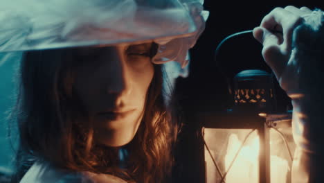 mysterious woman with a lantern in the dark