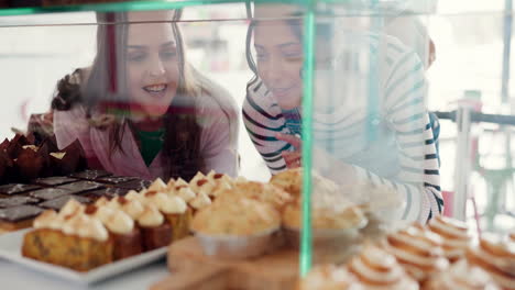 Bakery,-talking-and-women-looking-at-dessert