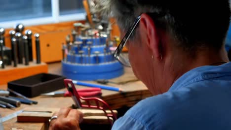 Craftswoman-working-in-workshop