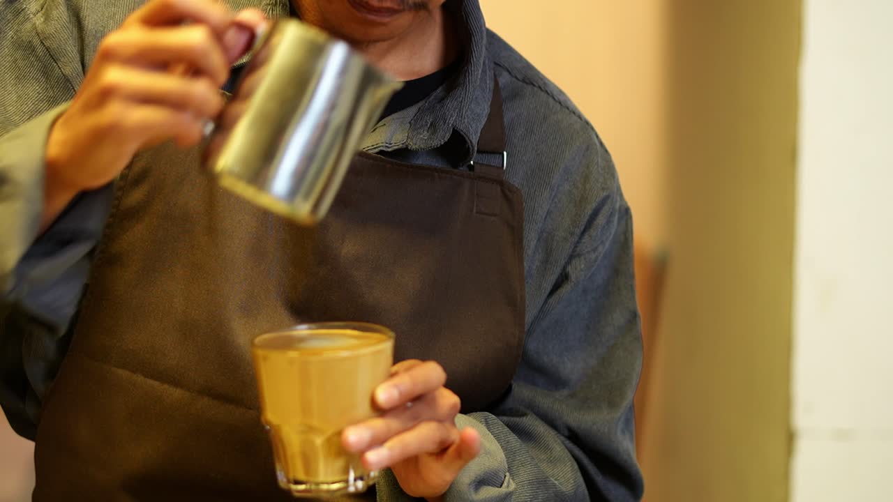 Barista Pouring Milk into Coffee