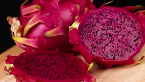 Sliced dragon fruit displayed on wooden board