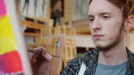 young artist painting in studio